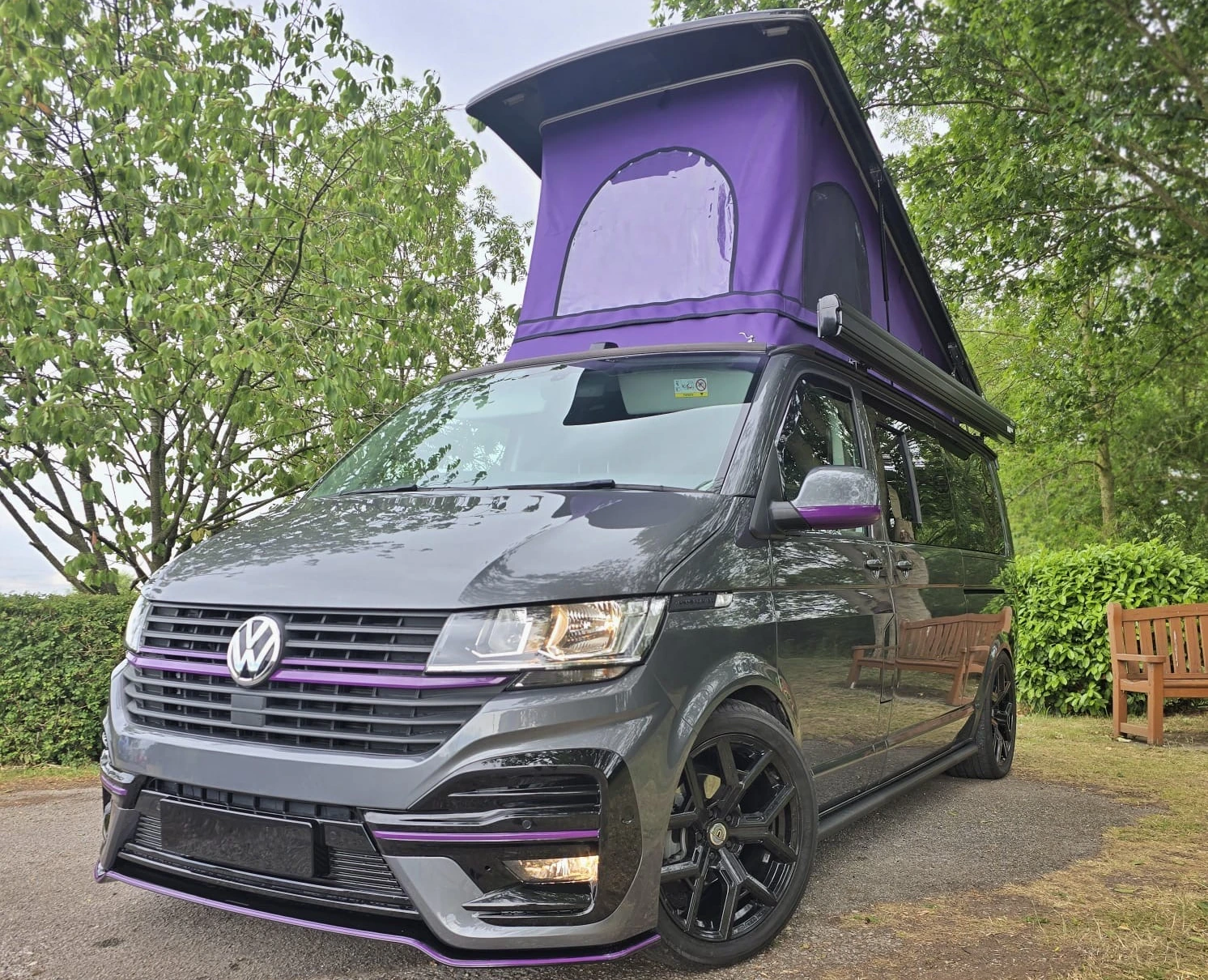 Grey campervan conversion with a raised purple pop-top roof, finished by JB Bodyworks
