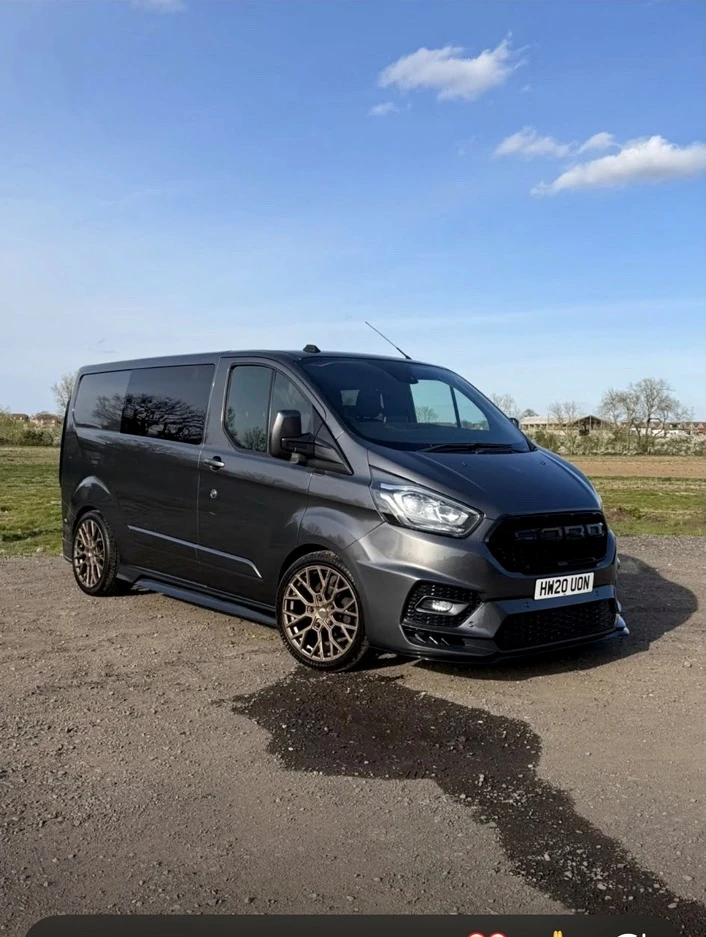 Grey custom-styled van with bodykit and bronze alloy wheels, finished by JB Bodyworks